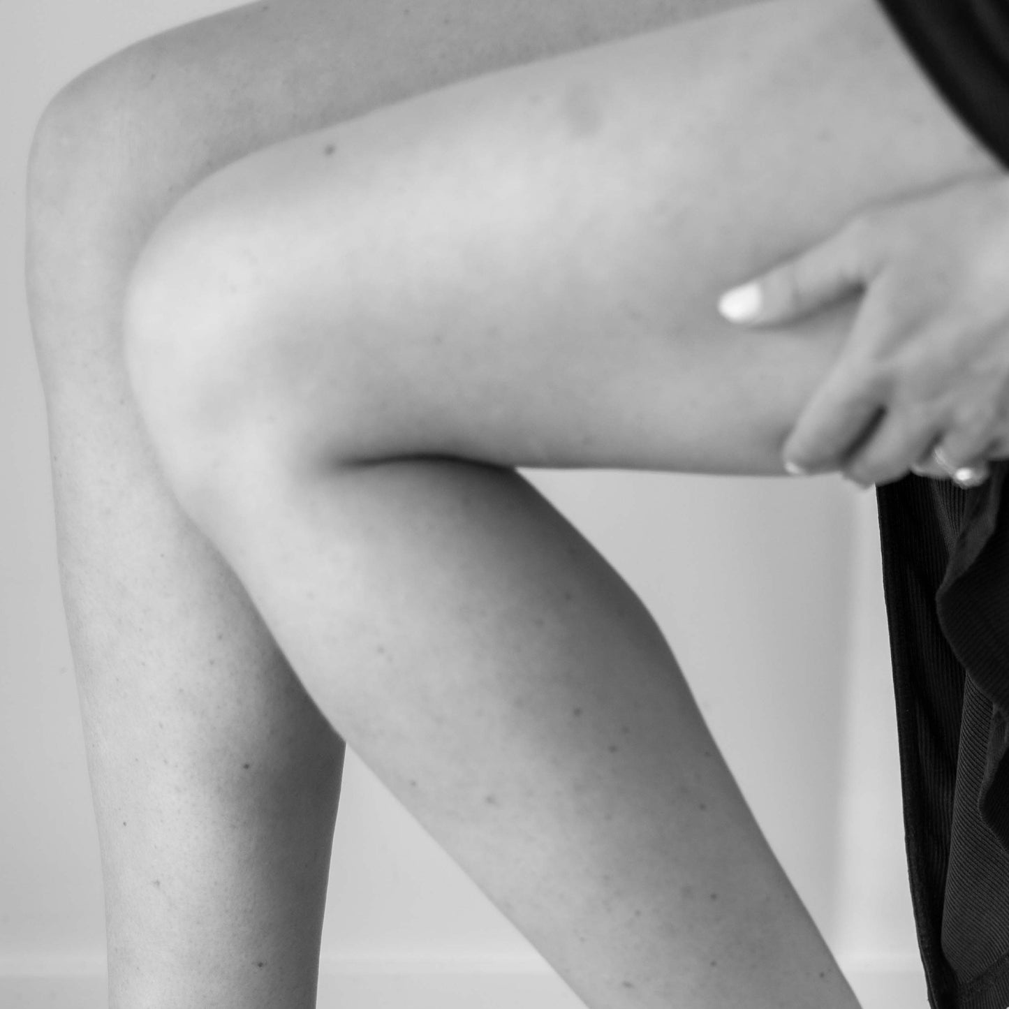 Person sitting on a white stool with one leg extended, promoting a Jin Shin Jyutsu workshop about Fascia
