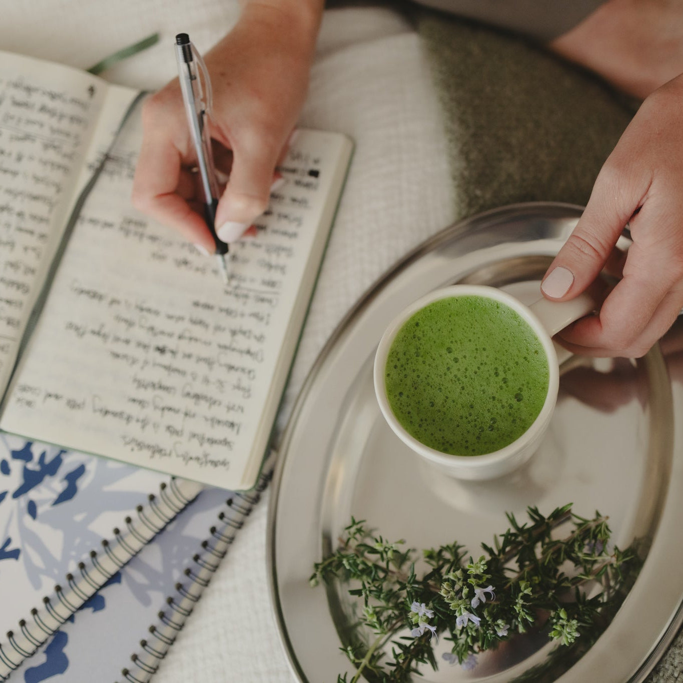 A Jin Shin Jyutsu student studying their notes at home during a 5 day basic seminar with their matcha to help with focus